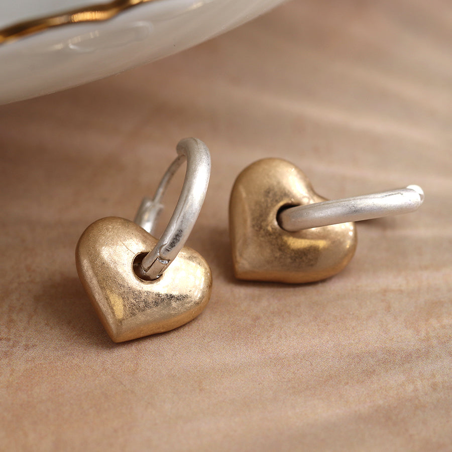 Pom - Worn Silver sleeper hoop and chunky smooth golden heart charm earrings